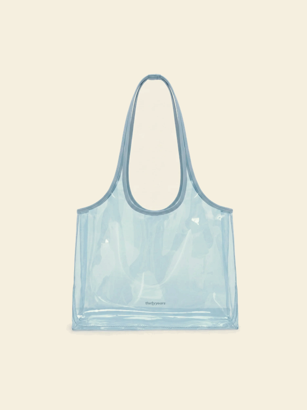A clear blue tote she has opened to her court