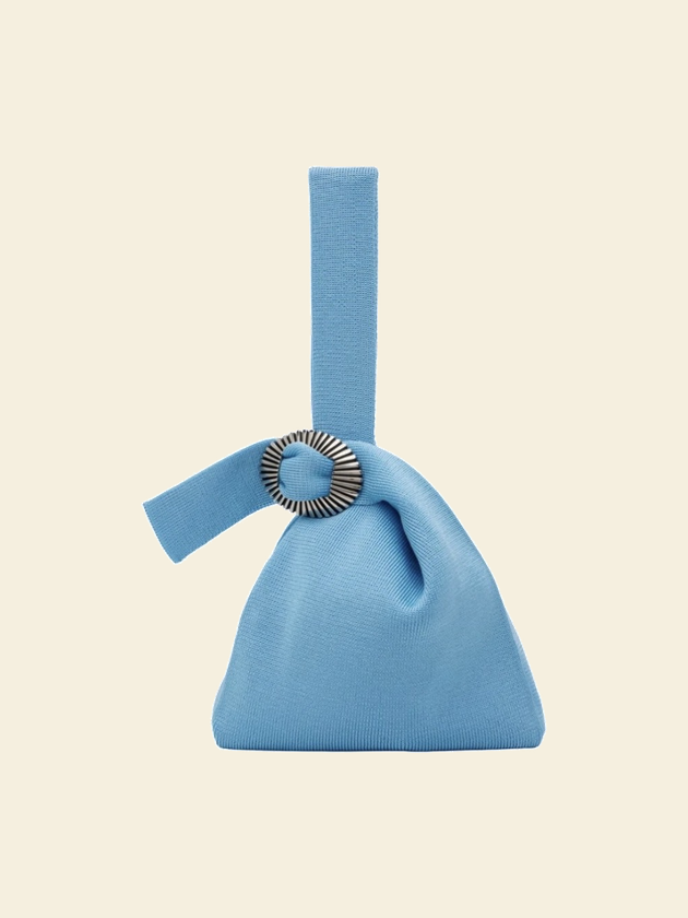 A blue knit tote she has opened to her court