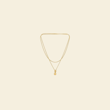 A layered gold necklace with a small pendant, cut out in the app.